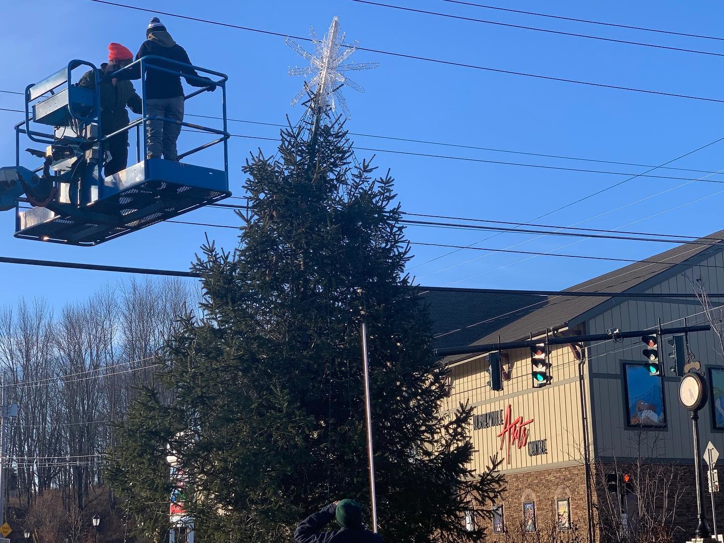 A tree is topped in preparation for the Holiday in Hurleyville event. Volunteers in towns and townships across the Upper Delaware River Valley adorned trees and made their Main Streets festive.